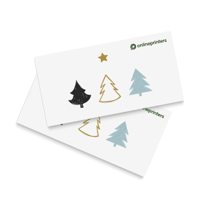 Due carte bianche sovrapposte presentano semplici illustrazioni di alberi e stelle nei toni del nero, dell'oro e del blu. La carta in alto mostra il logo di onlineprinters nell'angolo in alto a destra.